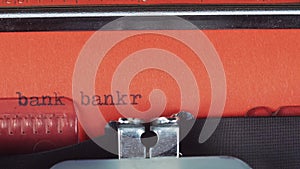 Bank bankrupt - Typed on a old vintage typewriter. Printed on red paper. The red paper is inserted into the typewriter