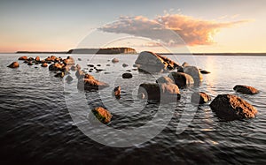 Bank with boulders and stones on sunset. Baltic sea, gulf of Finland