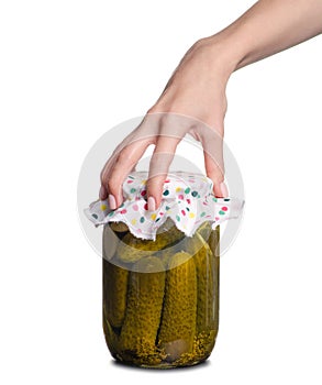 Bank of canned cucumbers in hand
