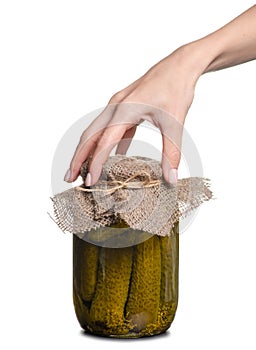 Bank of canned cucumbers in hand