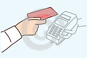 Bank card and POS terminal in hands of person for accepting contactless payment at checkout of store