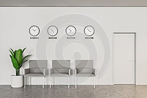 Bank or company waiting area, clocks and armchairs