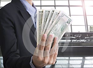 Bank employees hand holding money us dollar (USD) bills.