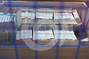 Bank employees sorting and counting money inside bank vault photo