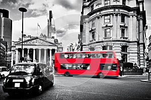 Bank of England, the Royal Exchange in London, the UK. Black taxi cab and red bus.