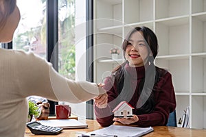 The bank mortgage officer or real estate agent handshake with customer deal after signing a house insurance, loan