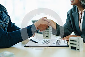 The bank's Mortgage Officers shake hands with customers to congratulate them after signing a housing investment loan