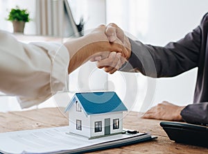 The bank's Mortgage Officers shake hands with customers to congratulate them after signing a housing investment loan