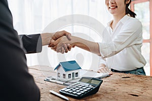 The bank's Mortgage Officers shake hands with customers to congratulate them after signing a housing investment loan