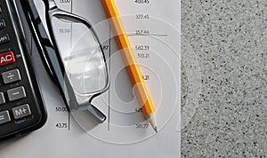 Bank statement with pencil glasses and calculator