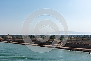 Bank of the Suez Canal, panorama view from transiting cargo ship.