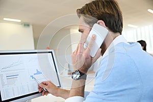 Bank trader negotiating stocks on the phone