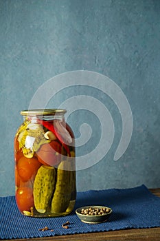 Bank with a variety of fermented cucumbers and tomatoes with seasonings