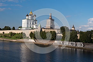 Bank of the Velikaya river. Installation `Russia begins here`. Pskov Kremlin in the morning. Trinity cathedral, Pskov