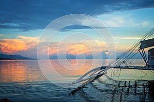 Banka, traditional filipino fishing boat at sunset, Cebu island The Philippines