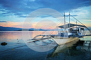 Banka, traditional filipino fishing boat at sunset, Cebu island, The Philippines