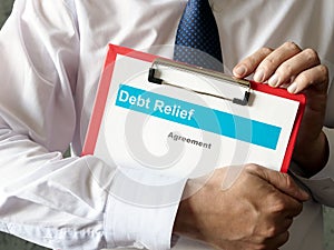 The banker holds the Debt relief agreement.