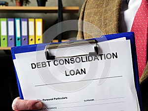 Banker offers Debt consolidation loan documents for filling in.