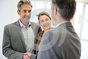 Banking advisor and clients handshaking