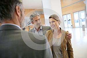Banking advisor and clients handshaking