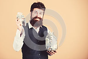 Banking concept. Man bearded guy hold jar full of cash savings. Safe place to keep money. Personal accountant