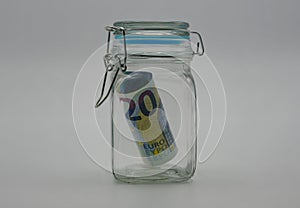 A banknote in an airtight glass jar. Concept of an emergency fund