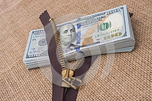 Banknote bundle of US dollar and brown zipper