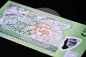 Banknote five Fijian dollars on a dark background