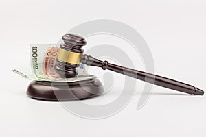 Banknote and judge`s hammer with financial concept isolated on gray background