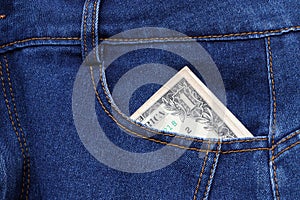 Banknote money one US dollar in the pocket of blue jeans