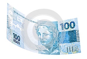 Banknote of one hundred reais from brazil falling on isolated white background photo