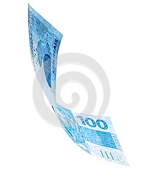 Banknote of one hundred reais from brazil falling on isolated white background