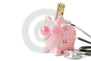 Banknote in piggy bank and Stethoscope isolated
