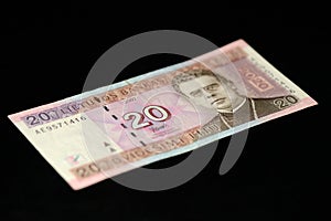 A banknote in twenty Lithuanian litas on a dark background