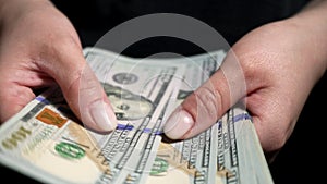 Banknotes of 100 dollars in female hands. Counting, count money.