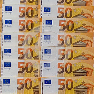 Banknotes of 50 fifty euros lie exactly in two rows. European currency, close-up. Blank for design, background.