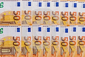 Banknotes of 50 fifty euros lie exactly in two rows. European currency, close-up. Blank for design, background. The horizontal