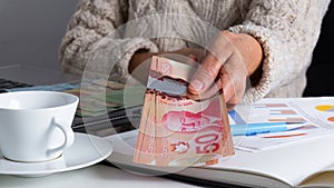 Banknotes of Canadian currency: Dollar. Old woman offering bills