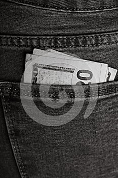 Banknotes close up, money in a jeans pocket. Dollars stick out of the jeans pocket, finance and currency concept. Concept of