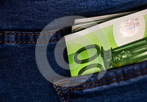 Banknotes close up, money in a jeans pocket. EURO stick out of the jeans pocket, finance and currency concept. Concept of saving