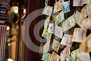 Banknotes from different countries glued to the wall