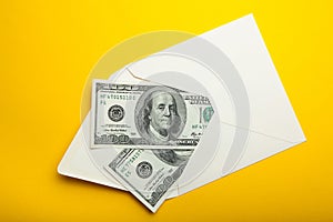 Banknotes in envelope, money in finance concept, isolated in yellow background