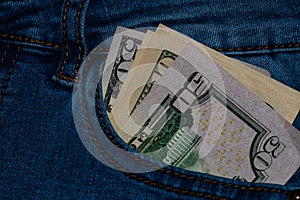 Banknotes, money in a jeans pocket, close up. Money stick out of the jeans pocket, finance and currency concept. Concept of rich