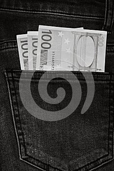 Banknotes, money in a jeans pocket, close up. Money stick out of the jeans pocket, finance and currency concept. Concept of rich