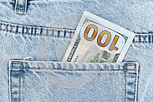 banknotes in the pocket of blue jeans. one hundred dollar bill.