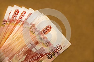 Banknotes of Russian currency face value of 5,000 rubles scattered on the table