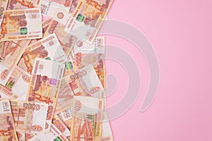Banknotes of russian rubles with a face value of five thousand, pink background, free space for text. The view from the top. Money