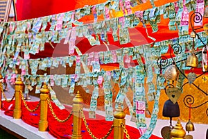 Banknotes sacrificed to Thai Angel in Bangkok, Thailand
