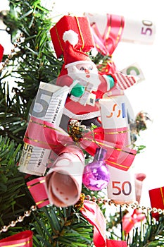 Banknotes and santa claus on christmas tree