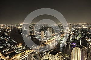 Bankok skyline by night highway and river traffic